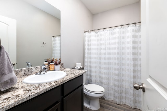 bathroom featuring hardwood / wood-style floors, toilet, and vanity