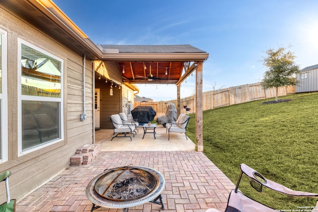 view of patio / terrace with ceiling fan, a fire pit, and area for grilling