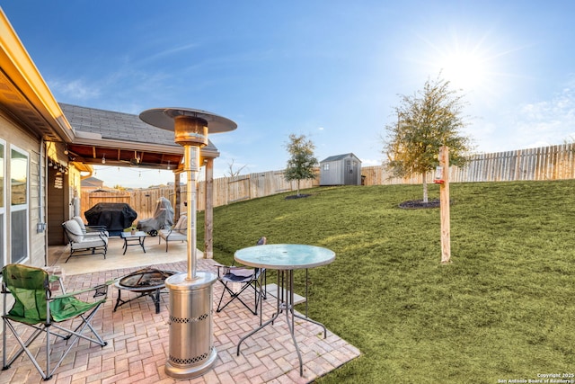 view of yard featuring a storage unit, a patio, and an outdoor fire pit