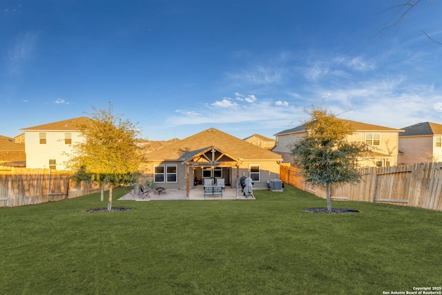 back of house featuring cooling unit, a yard, and a patio