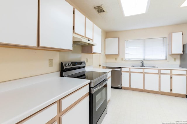 kitchen with white cabinets, stainless steel appliances, and sink