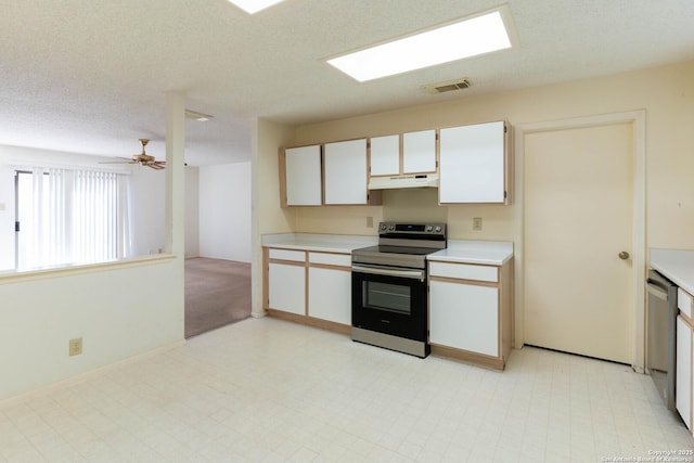 kitchen featuring ceiling fan, a textured ceiling, white cabinets, and stainless steel appliances