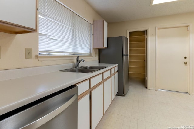 kitchen featuring white cabinets, appliances with stainless steel finishes, and sink