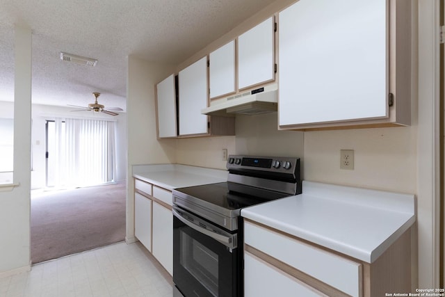 kitchen with stainless steel electric range oven, white cabinets, a textured ceiling, and ceiling fan