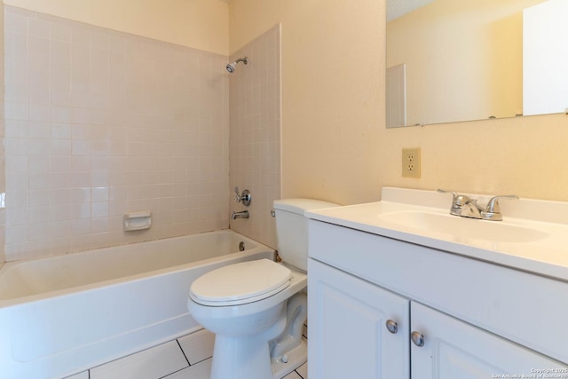 full bathroom featuring toilet, tile patterned floors, vanity, and tiled shower / bath