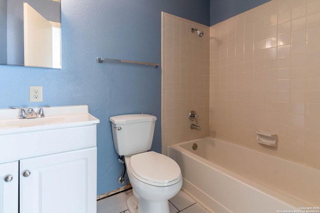 full bathroom with vanity, toilet, tiled shower / bath, and tile patterned floors