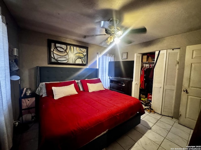 tiled bedroom featuring ceiling fan and a textured ceiling