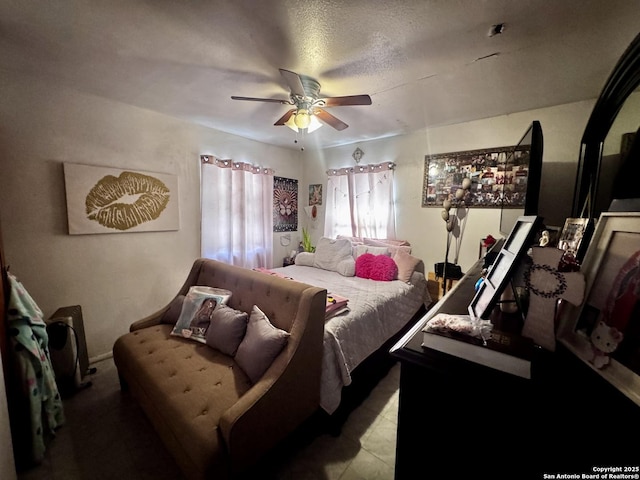 bedroom with ceiling fan and a textured ceiling