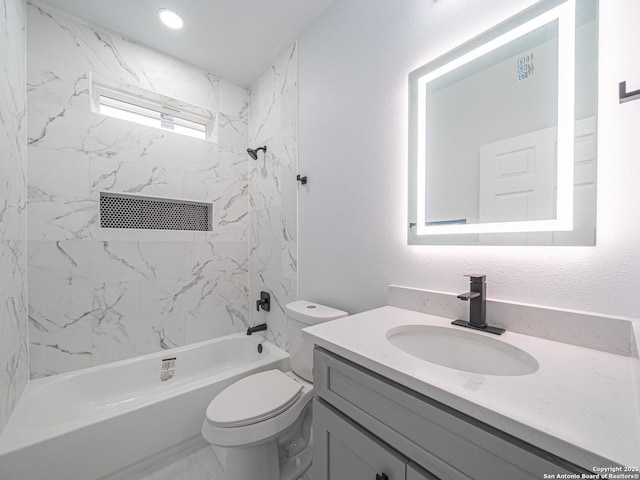 full bathroom featuring vanity, toilet, and tiled shower / bath combo