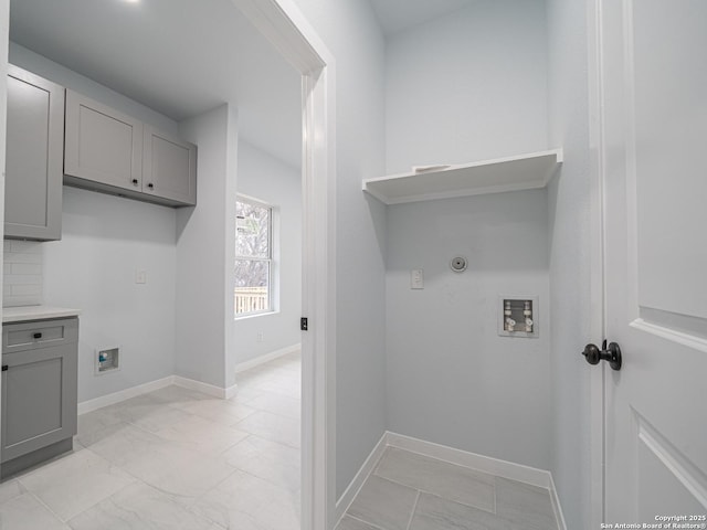 washroom featuring washer hookup and cabinets