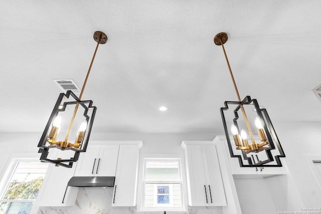 room details with pendant lighting and white cabinetry