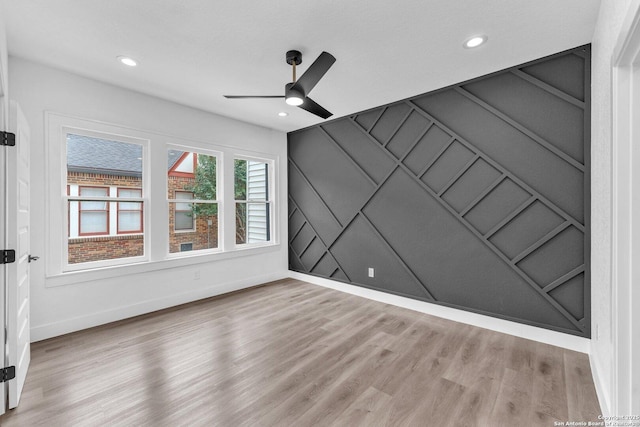 spare room featuring light hardwood / wood-style floors and ceiling fan