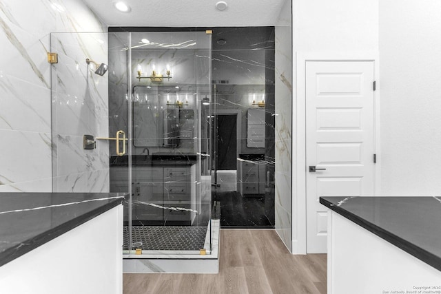 bathroom with hardwood / wood-style floors and a shower with door