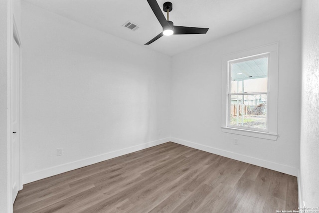 spare room with hardwood / wood-style flooring and ceiling fan