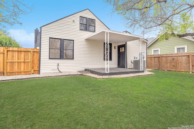 rear view of house featuring a lawn