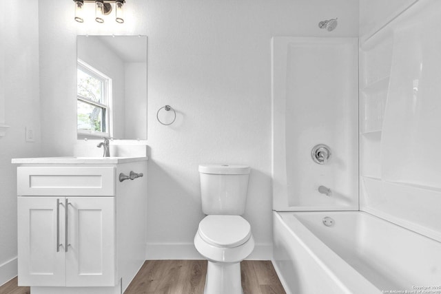 full bathroom featuring washtub / shower combination, wood-type flooring, toilet, and vanity