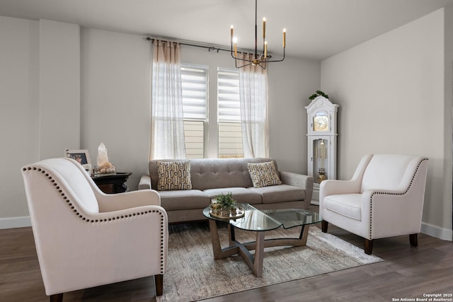 living room with dark hardwood / wood-style flooring and a notable chandelier