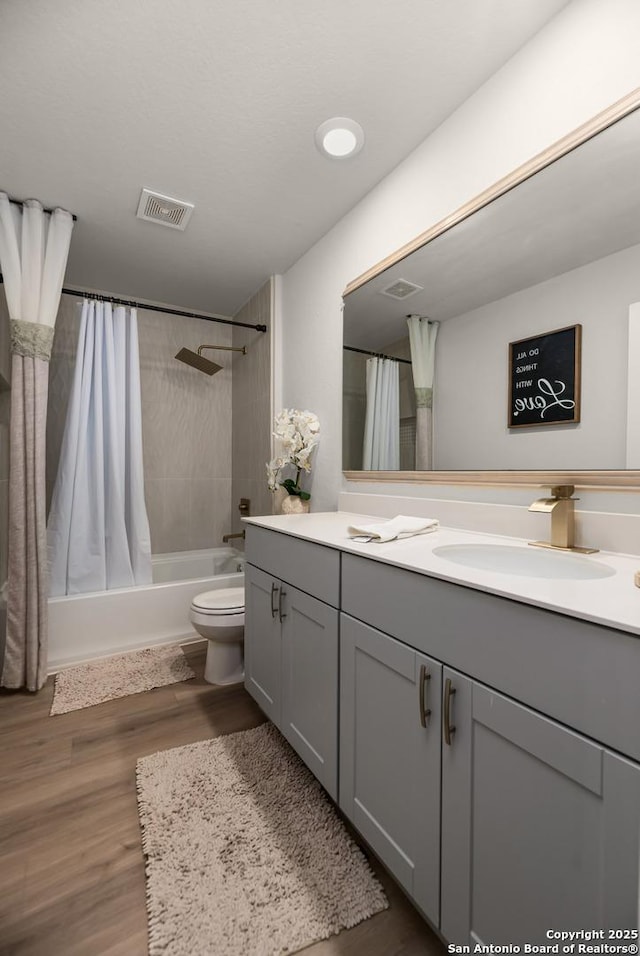 full bathroom with vanity, toilet, shower / tub combo with curtain, and wood-type flooring