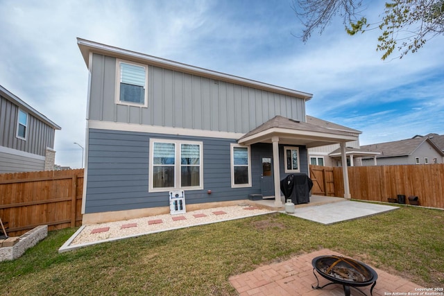 back of property featuring a patio, an outdoor fire pit, and a lawn