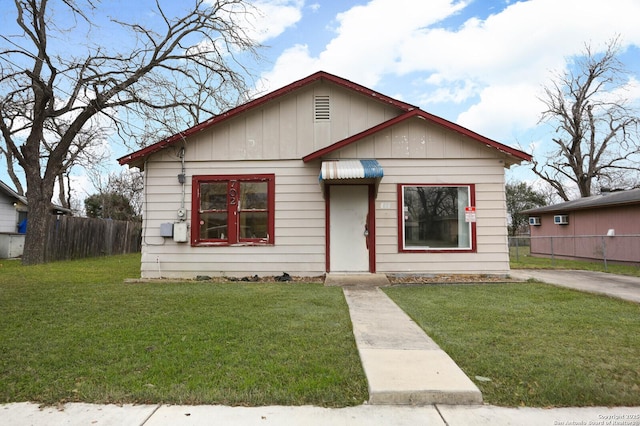 bungalow-style home with a front lawn