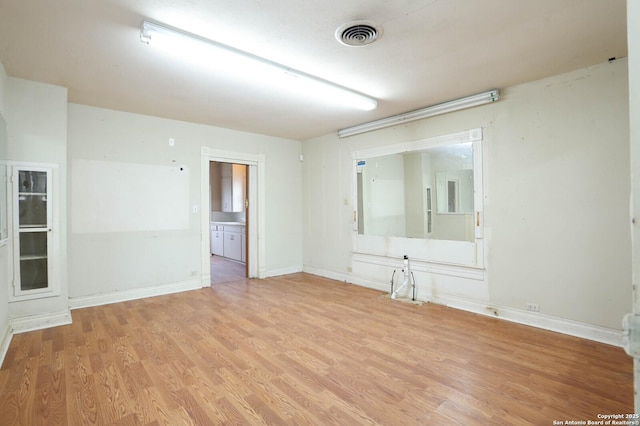 unfurnished room with light wood-type flooring