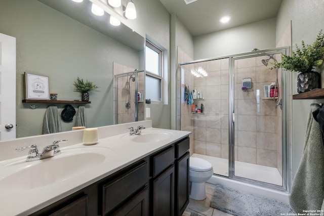 bathroom with vanity, toilet, walk in shower, and tile patterned floors