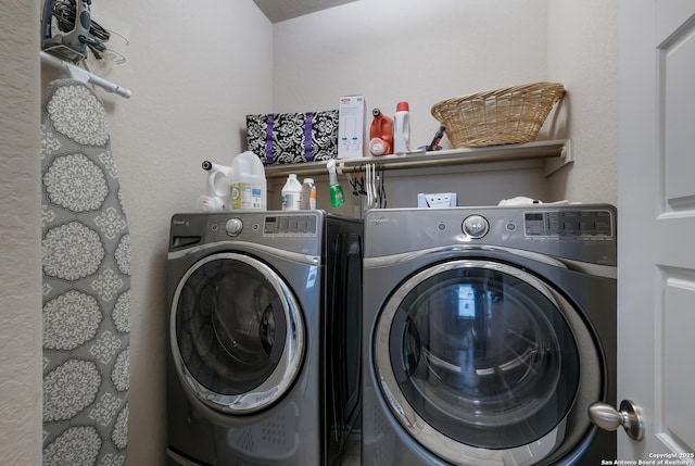 washroom featuring separate washer and dryer and a textured ceiling