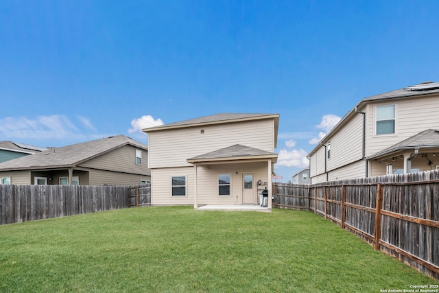 rear view of property featuring a patio area and a yard