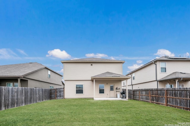 rear view of property with a lawn and a patio