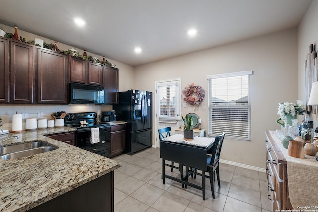 kitchen featuring dark brown cabinets, black appliances, tasteful backsplash, and light tile patterned floors