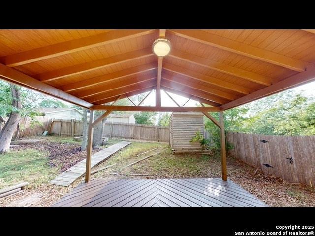 wooden terrace with a storage shed