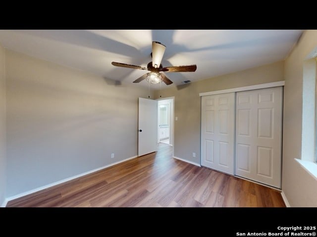 unfurnished bedroom featuring a closet, ceiling fan, and light hardwood / wood-style flooring