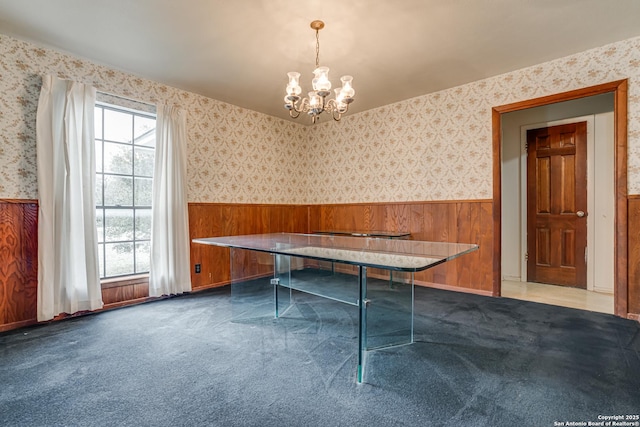 recreation room with wooden walls, plenty of natural light, and carpet flooring