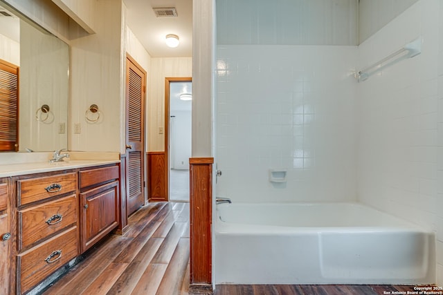 bathroom featuring a tub, wood-type flooring, and vanity