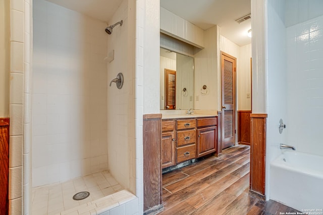 bathroom featuring vanity and shower with separate bathtub