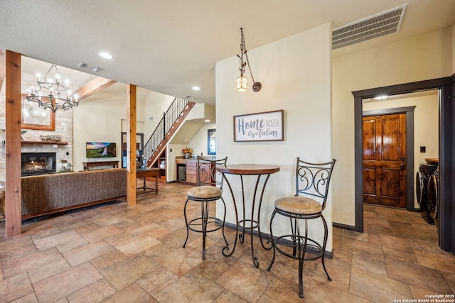 dining area featuring a large fireplace and washer and clothes dryer