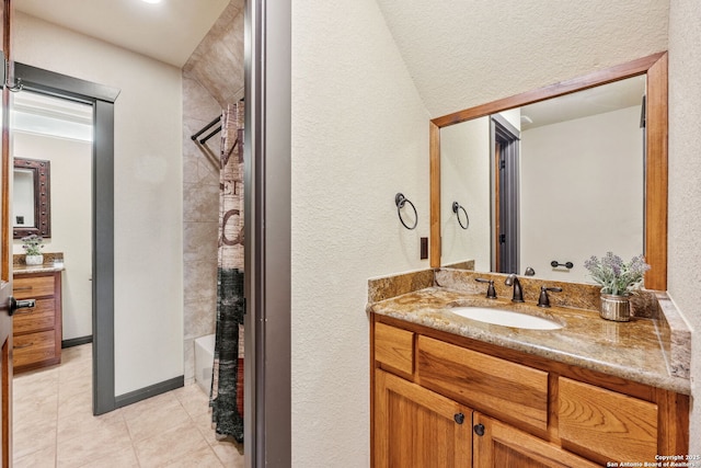 bathroom with vanity, tile patterned flooring, and shower / bath combo with shower curtain