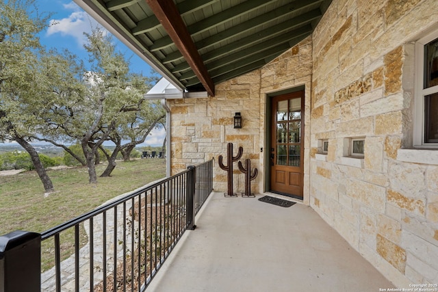 view of exterior entry featuring a balcony