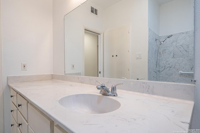 bathroom with a shower and vanity