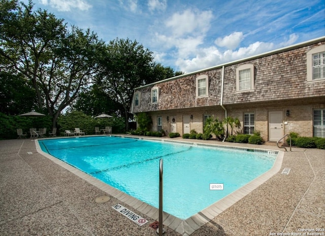 view of swimming pool featuring a patio area