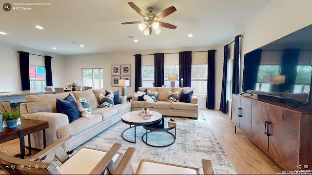 living room featuring light wood-type flooring and ceiling fan