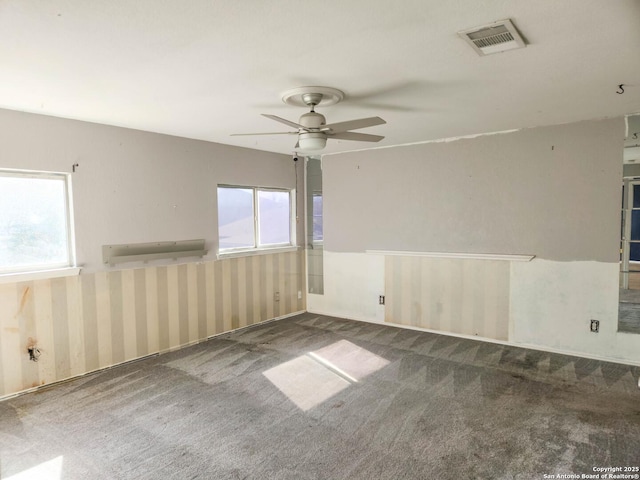 carpeted empty room featuring ceiling fan