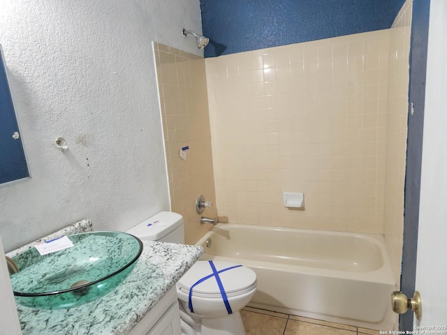 full bathroom with vanity, toilet, tiled shower / bath, and tile patterned flooring