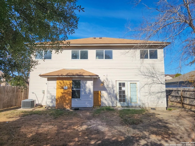 rear view of house featuring central AC