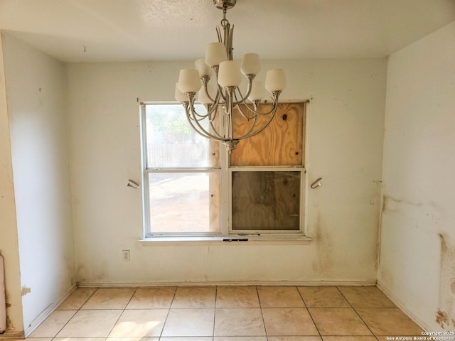 unfurnished dining area with an inviting chandelier