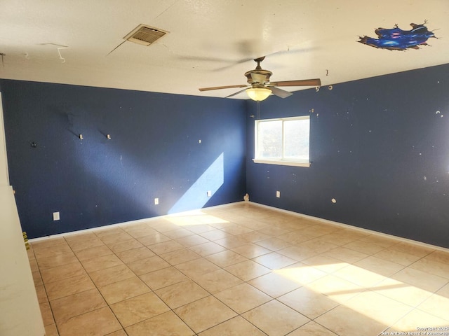 empty room featuring light tile patterned floors and ceiling fan