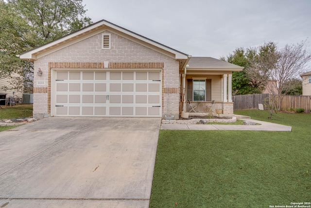 ranch-style home with a garage, a front lawn, and covered porch