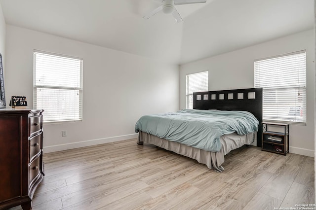 bedroom featuring multiple windows, light hardwood / wood-style flooring, and ceiling fan