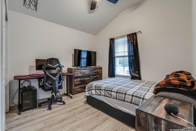 bedroom with lofted ceiling, light hardwood / wood-style floors, and ceiling fan