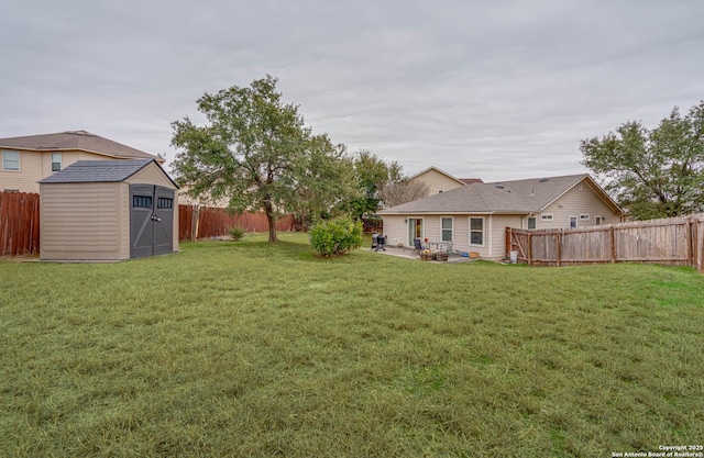 view of yard with a patio area and a storage unit